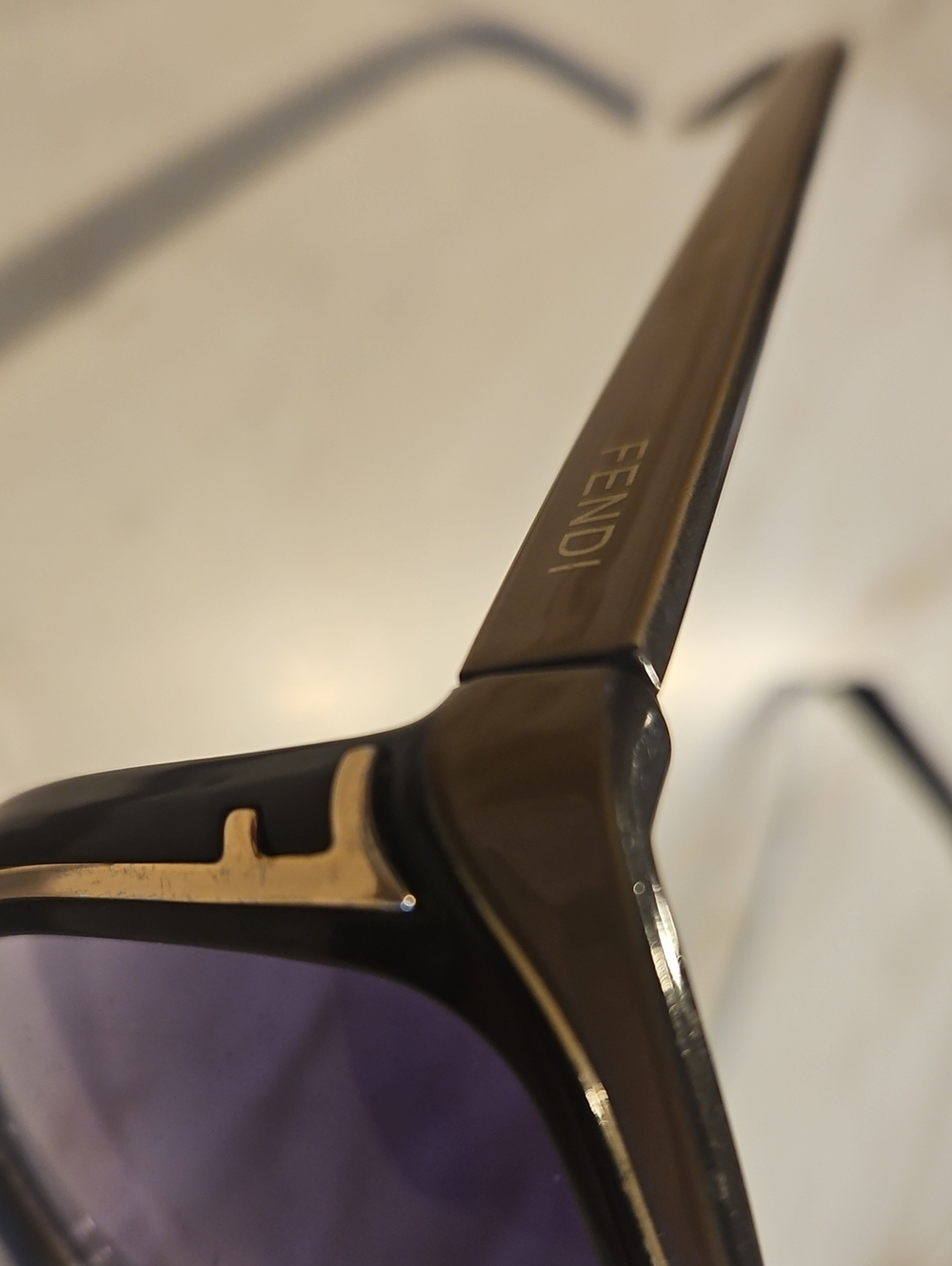 Fendi Black Frame Sunglasses with Gold Accents and Purple Lenses